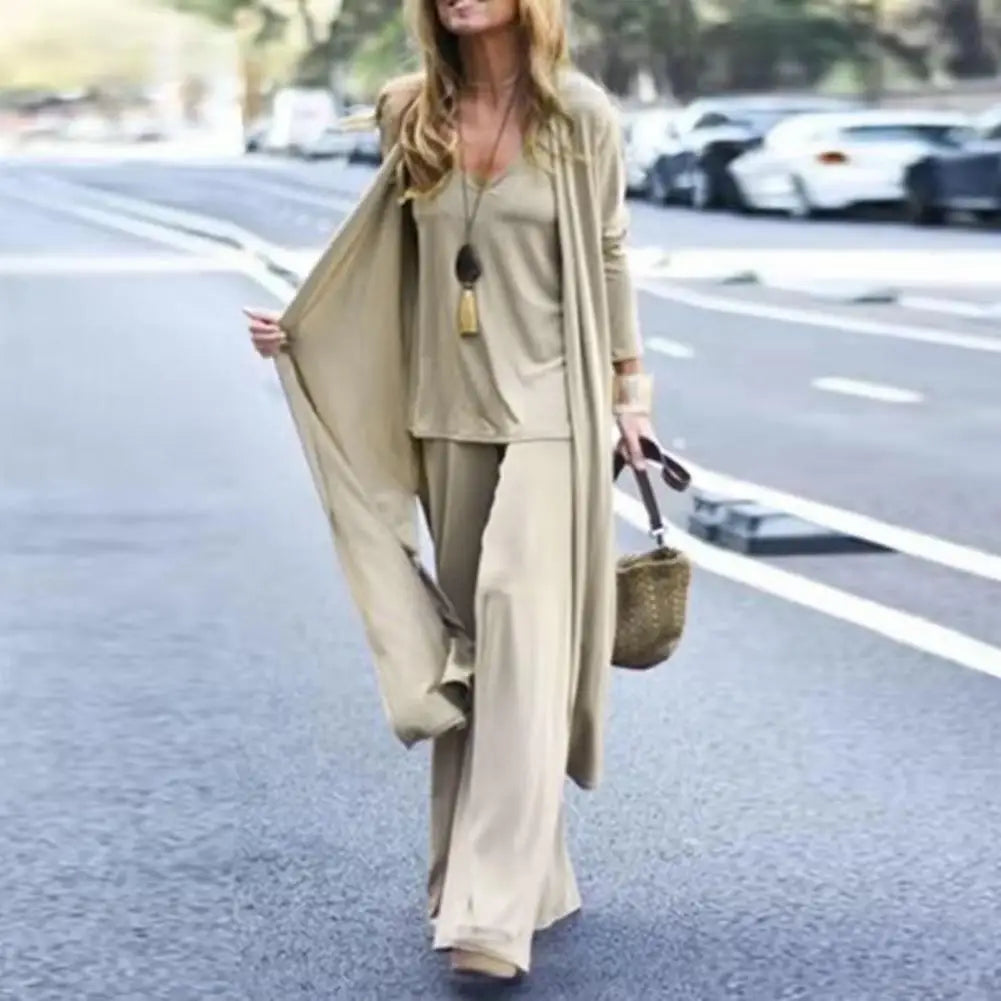 SETS - Chic and slimming, this solid-color three-piece casual outfit epitomizes versatility and style. The ensemble is ideal for any occasion and includes a V-neck camisole, wide-leg trousers, and a flowing long cardigan, all